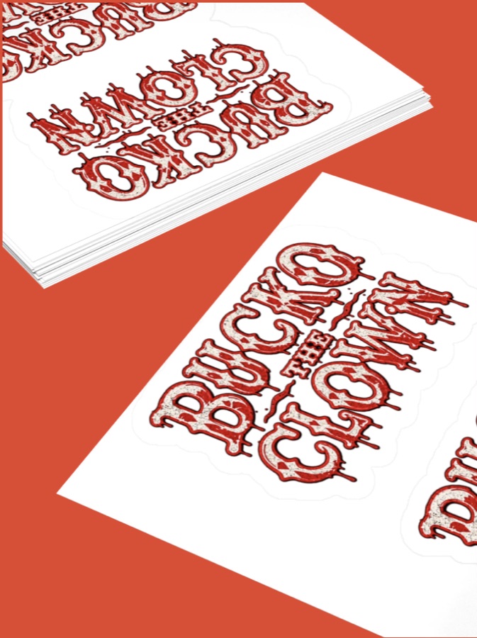 Bucko logo sticker sheet on terracotta, stack of sheets in the corner